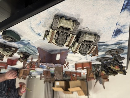Vehicles line up behind ruined walls